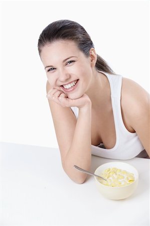 Young girl at breakfast on a white background Stock Photo - Budget Royalty-Free & Subscription, Code: 400-04340889