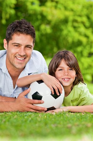 Father and his son with their ball in the park Stock Photo - Budget Royalty-Free & Subscription, Code: 400-04340971