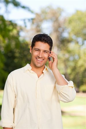Handsome man phoning in the park Stock Photo - Budget Royalty-Free & Subscription, Code: 400-04341014