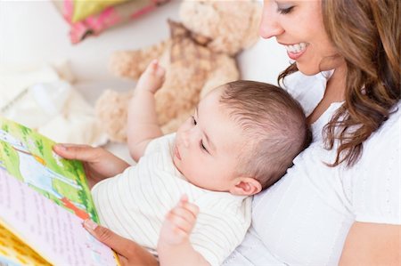 Joyful mother showing images in a book to her cute little son at home Stock Photo - Budget Royalty-Free & Subscription, Code: 400-04341622