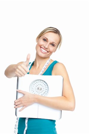 Attractive young woman holding a weight scale looking at the cmera over white backgroud Stock Photo - Budget Royalty-Free & Subscription, Code: 400-04341651