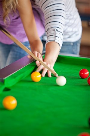 Attentive boyfriend learning his girlfriend how to play pool in a club Stock Photo - Budget Royalty-Free & Subscription, Code: 400-04341783