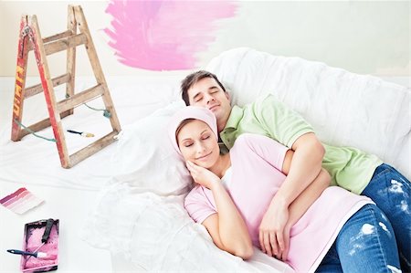 simsearch:400-04878558,k - Delighted couple lying on the sofa after painting their new room in their new house Stock Photo - Budget Royalty-Free & Subscription, Code: 400-04341828