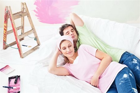 simsearch:400-04878558,k - Relaxing couple lying on the sofa after painting their new room in their new house Stock Photo - Budget Royalty-Free & Subscription, Code: 400-04341829