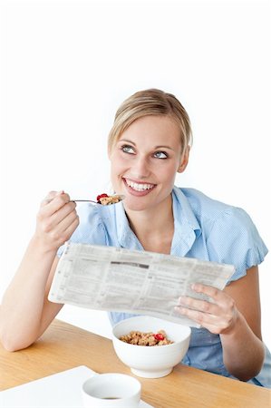 simsearch:400-04209411,k - Glowing businesswoman having breakfast and reading a newspaper sitting against a white background Fotografie stock - Microstock e Abbonamento, Codice: 400-04341834