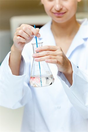 simsearch:400-05670362,k - Portrait of a female scientist shaking liquid in an erlenmeyer in her laboratory Stock Photo - Budget Royalty-Free & Subscription, Code: 400-04341854
