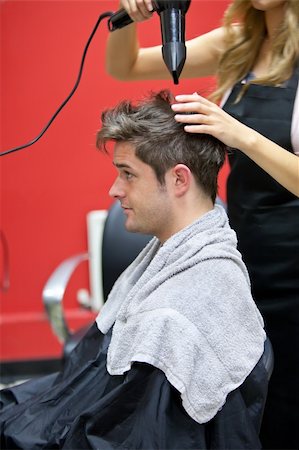 Female hairdresser drying her male customer's hair in her salon Foto de stock - Super Valor sin royalties y Suscripción, Código: 400-04341860