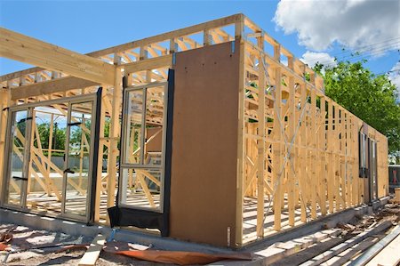 simsearch:400-05344387,k - New residential construction home framing against a blue sky Stock Photo - Budget Royalty-Free & Subscription, Code: 400-04341894