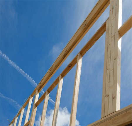 simsearch:400-05344387,k - New residential construction home framing against a blue sky Stock Photo - Budget Royalty-Free & Subscription, Code: 400-04341895