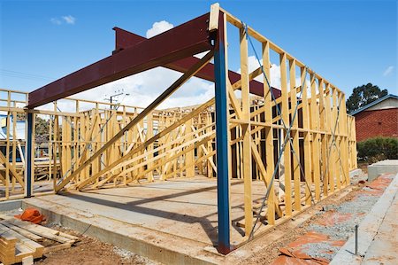 simsearch:400-05344387,k - New residential construction home framing against a blue sky Stock Photo - Budget Royalty-Free & Subscription, Code: 400-04341893