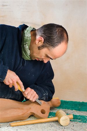 sculptor chisel man - Sculptor working on a wooden statue in his studio Stock Photo - Budget Royalty-Free & Subscription, Code: 400-04342100
