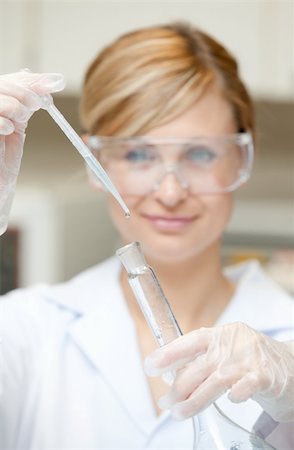 Portrait of a charming female scientist using a pipette in her laboratory Stock Photo - Budget Royalty-Free & Subscription, Code: 400-04342134