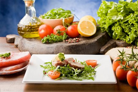 photo of sliced Tuna Steak with arugula salad and ingredients arround Stock Photo - Budget Royalty-Free & Subscription, Code: 400-04342624