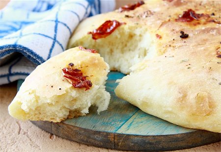 foccacia - Italian Focaccia bread with tomatoes on a cutting board Stock Photo - Budget Royalty-Free & Subscription, Code: 400-04342652