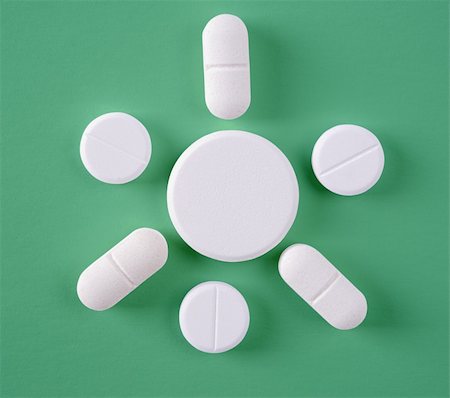 Some of White pills on a green background Stock Photo - Budget Royalty-Free & Subscription, Code: 400-04342858