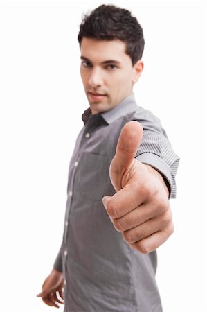 simsearch:400-04343310,k - Handsome young man with thumbs up on an isolated white background, focus is on the hand Photographie de stock - Aubaine LD & Abonnement, Code: 400-04343309