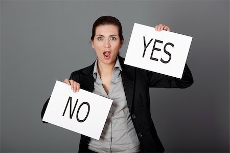 Business young woman trying to make a decision between Yes or No choice, over a gray background Stock Photo - Budget Royalty-Free & Subscription, Code: 400-04343341