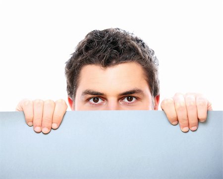 simsearch:400-05368656,k - A portrait of a young man holding a banner over white background Stockbilder - Microstock & Abonnement, Bildnummer: 400-04343466