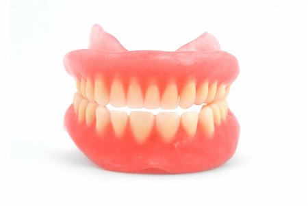 Plastic dentures on a white background Photographie de stock - Aubaine LD & Abonnement, Code: 400-04343609