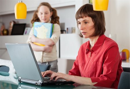 Mother and teenager girl with laptop computer together at home Stock Photo - Budget Royalty-Free & Subscription, Code: 400-04343904