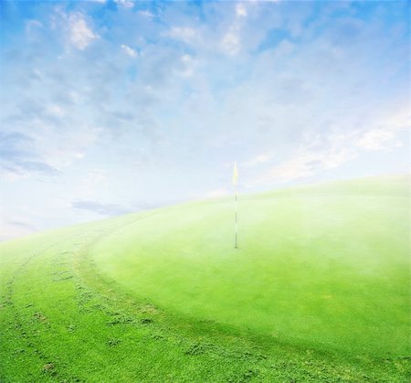 landscape of a green golf field with clouds and morning fog.  Shallow focus. Stock Photo - Budget Royalty-Free & Subscription, Code: 400-04354496