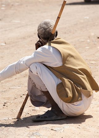 Local Egyptian bedouin man sitting by the side of road Stock Photo - Budget Royalty-Free & Subscription, Code: 400-04354725