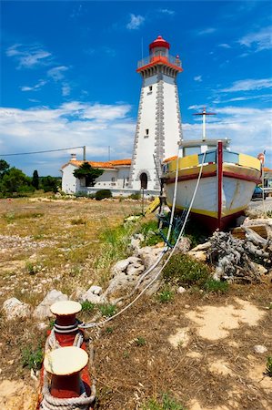 Red and white lighthouse on mediterranean coastline, France Stock Photo - Budget Royalty-Free & Subscription, Code: 400-04354842