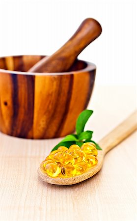 Fish oil a wooden spoon, mortar with a pestle. Stock Photo - Budget Royalty-Free & Subscription, Code: 400-04354860