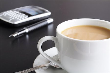 cup of coffee in the business office showing success Stockbilder - Microstock & Abonnement, Bildnummer: 400-04355623
