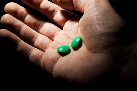 Two green pills on the opened palm Stock Photo - Budget Royalty-Free & Subscription, Code: 400-04357370