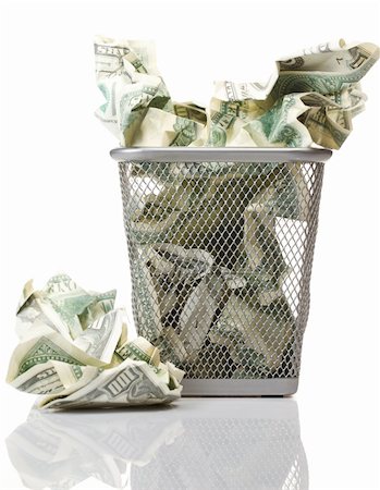 paper waste in office - Money in basket. Isolated over white. Foto de stock - Super Valor sin royalties y Suscripción, Código: 400-04358044