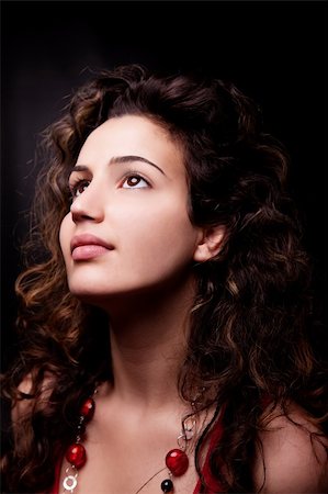 Young and attractive woman looking up smiling, isolated on black, studio shot Stock Photo - Budget Royalty-Free & Subscription, Code: 400-04358385