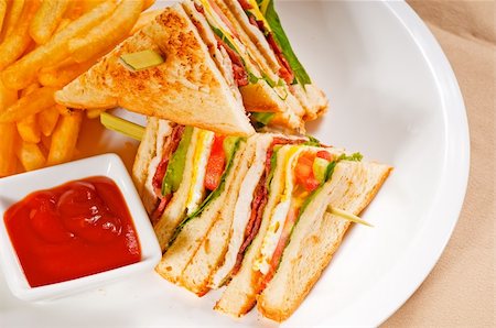 simsearch:400-08188042,k - fresh triple decker club sandwich with french fries on side Photographie de stock - Aubaine LD & Abonnement, Code: 400-04358436