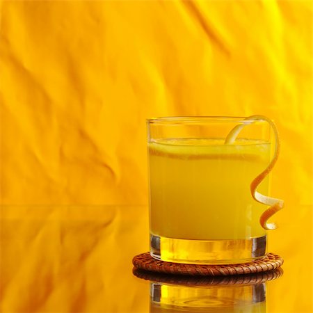 drink coaster - Fresh orange juice in glass with orange peel on orange background (Selective Focus) Stock Photo - Budget Royalty-Free & Subscription, Code: 400-04359319