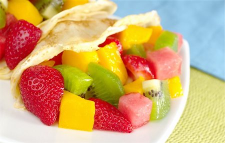 Crepes filled with fresh fruits (strawberry, kiwi, mango, watermelon) (Selective Focus, Focus on the fruits in the lower left corner) Stock Photo - Budget Royalty-Free & Subscription, Code: 400-04359720