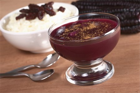 Peruvian dessert called Mazamorra Morada made out of purple corn with rice pudding in the back, which is sometimes served with it (Selective Focus, Focus on the front of the bowl) Foto de stock - Super Valor sin royalties y Suscripción, Código: 400-04359750