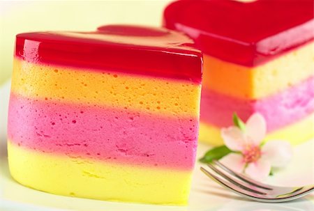 father's day - Colorful Peruvian heart-shaped jelly-pudding cakes called Torta Helada with a peach blossom and a fork on the plate (Selective Focus, Focus on the front surface of the left cake) Stock Photo - Budget Royalty-Free & Subscription, Code: 400-04350345