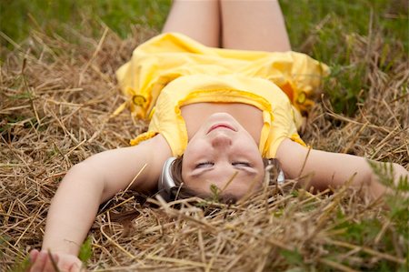 Young beautiful girl in yellow with headphones at field. Stock Photo - Budget Royalty-Free & Subscription, Code: 400-04350820