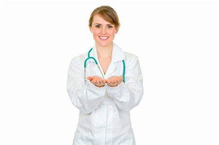 simsearch:400-04351236,k - Smiling female medical doctor presenting something on empty hands isolated on white Photographie de stock - Aubaine LD & Abonnement, Code: 400-04351236