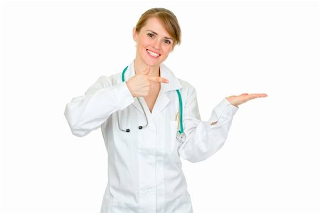 simsearch:400-04351236,k - Smiling female medical doctor pointing finger on empty hand  isolated on white Photographie de stock - Aubaine LD & Abonnement, Code: 400-04351238