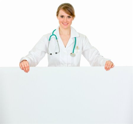 simsearch:400-04351236,k - Smiling medical doctor woman holding blank billboard  isolated on white Photographie de stock - Aubaine LD & Abonnement, Code: 400-04351232