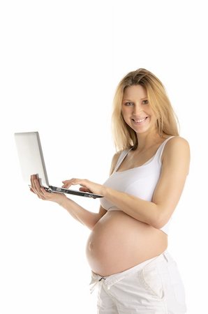 relish - Happy pregnant woman with laptop isolated on white Photographie de stock - Aubaine LD & Abonnement, Code: 400-04351280