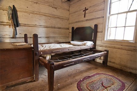 frontier - Interior of a historic pioneer house with an old bed Stock Photo - Budget Royalty-Free & Subscription, Code: 400-04351438