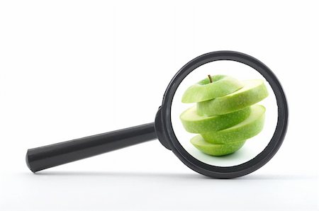 magnifying glass and sliced apple isolated on white Stock Photo - Budget Royalty-Free & Subscription, Code: 400-04352111