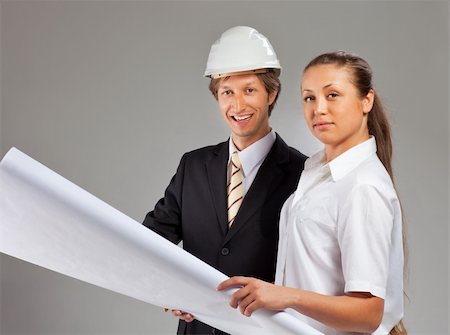 shirt technical sketch - An architect wearing a hard hat and co-worker reviewing blueprints Stock Photo - Budget Royalty-Free & Subscription, Code: 400-04352809