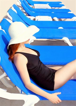 simsearch:400-09151171,k - Mid age tourist woman sun tanning blue hammock row beach hat Stock Photo - Budget Royalty-Free & Subscription, Code: 400-04352841