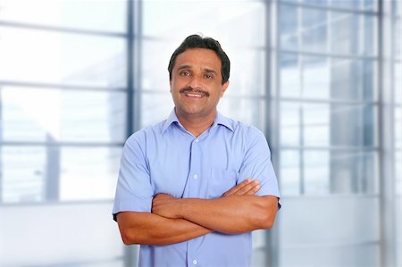 signs for mexicans - Indian latin businessman blue shirt in modern office background Foto de stock - Super Valor sin royalties y Suscripción, Código: 400-04352859