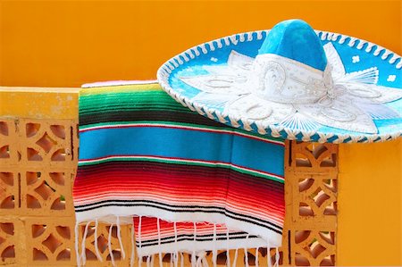 charro mariachi blue mexican hat serape poncho over orange tiles wall Fotografie stock - Microstock e Abbonamento, Codice: 400-04352884