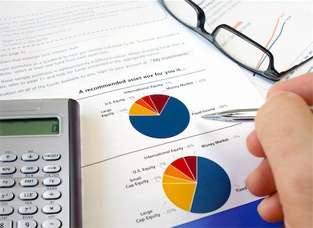 simsearch:400-07407735,k - Male hand with pen on the pie investment chart with calculator and glasses Stock Photo - Budget Royalty-Free & Subscription, Code: 400-04353120