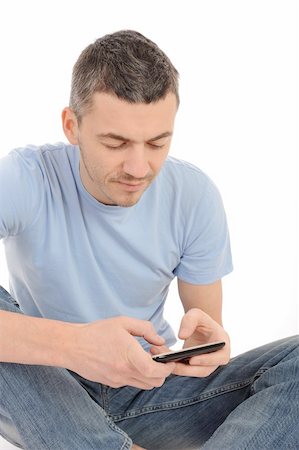 simsearch:400-05751258,k - casual young man sending sms on the mobile phone. isolated Stock Photo - Budget Royalty-Free & Subscription, Code: 400-04353227